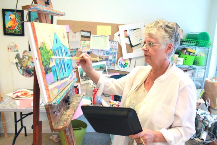 Maggie Ruley paints in tropical tones - A person standing in front of a laptop - Florida Keys