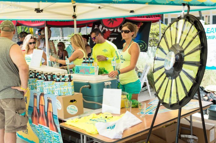 Key West BrewFest on tap for Labor Day weekend - A group of people standing around a table - Vehicle