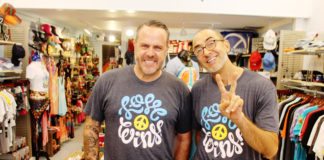 “LOVE WINS” designs debut at the Peace Store - A man standing in front of a shop - T-shirt