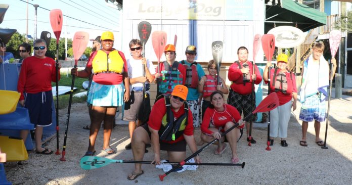 Locals invited to participate in SUP races this weekend - A group of people posing for the camera - Product