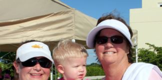 Breast cancer survivor Trich Worthington believes in regular physicals - A man and a woman holding a cake - Sunglasses