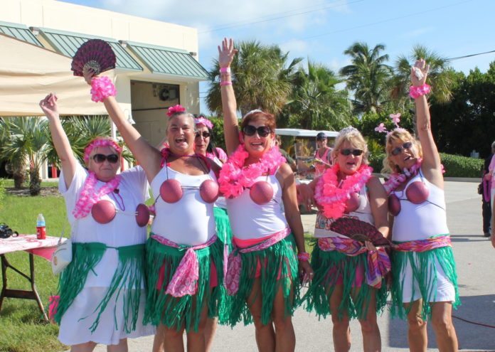Hundreds join cancer walk - A group of people posing for a picture - Hula