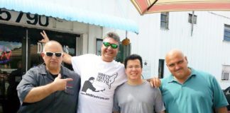 Pre-Thanksgiving Feast happens on Stock Island - A group of people standing in front of a building - Sunglasses