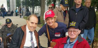 Two local Vets honored here, events - Bob Dole et al. sitting on a bench posing for the camera - Car