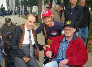 Two local Vets honored here, events - Bob Dole et al. sitting on a bench posing for the camera - Car