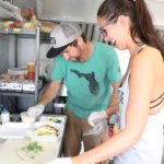 Let’s Taco ‘bout the Food Truck Festival - A person preparing food in a kitchen - Food truck