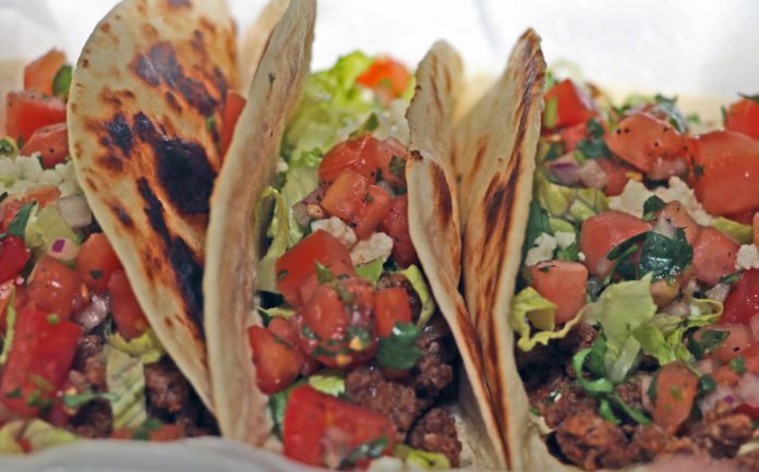 Let’s Taco ‘bout the Food Truck Festival - A dish is filled with food - Taco