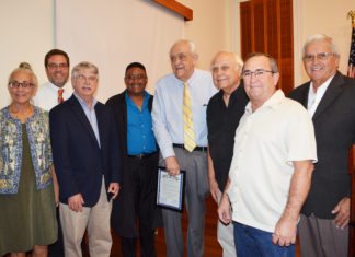 City puts the brakes on rushed bid - A group of people posing for a photo - Businessperson