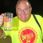 Beer and bubbly flows at fest - A man holding a glass of beer - Liqueur