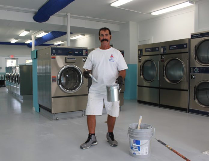 It’s coming … Laundromat set to open soon - A person standing in a kitchen - Self-service laundry