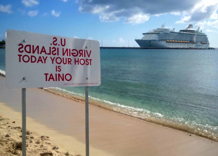 Stop and look both ways – Public art installation - A sign on a beach near a body of water - Cruise ship