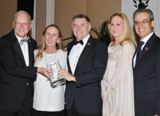 Beaver and Whitt named ‘Humanitarians’ - Alfred Sanchez et al. standing next to a person in a suit and tie - Florida Keys