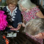 Pre-gala reception honors donors - A group of people sitting at a table with a cake - Florida Keys