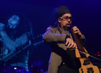 A man sitting on a stage - Matthieu Chedid