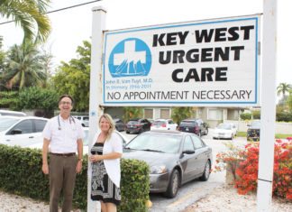 Dr. Brian Wagstaff finds his home in Key West - A group of people standing in front of a sign - Wagstaff Brian MD