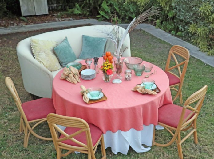 A pretty place (setting) - A couple of lawn chairs sitting on top of a picnic table - Tablecloth