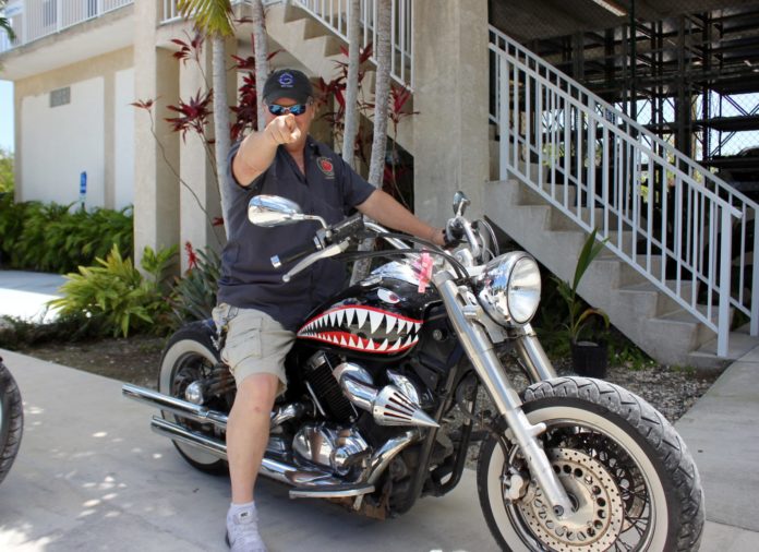 20 questions with Bill Hoebee - A man riding a motorcycle on the side of a building - Car tires