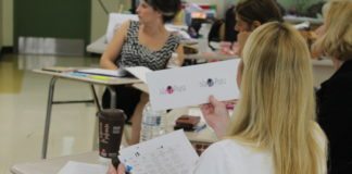 Entrepreneurial students ‘draws’ real life experience - A group of people sitting at a table using a laptop - Girl