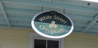 Key West welcomes Bruce and Denise Lieske: - A clock hanging off the side of a building - 