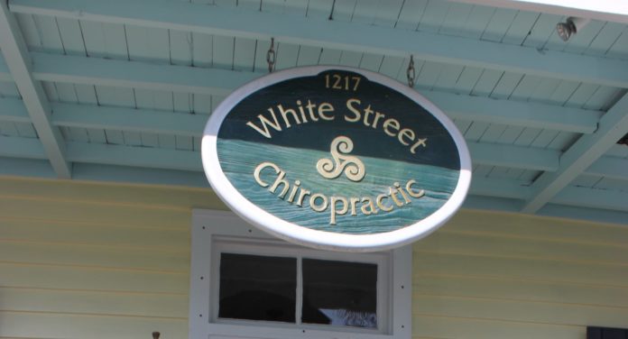 Key West welcomes Bruce and Denise Lieske: - A clock hanging off the side of a building - 