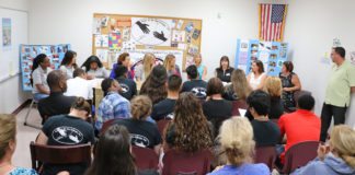 Teens host town hall meeting - A group of people in a room - Public Relations