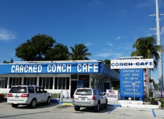Cracked Conch is hub during big storms - A sign above a store in a parking lot - Cracked Conch Cafe