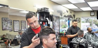 Marathon barbers rock, make paper, with scissors - A man standing next to a motorcycle - Carlos Quintana