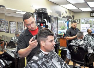 Marathon barbers rock, make paper, with scissors - A man standing next to a motorcycle - Carlos Quintana