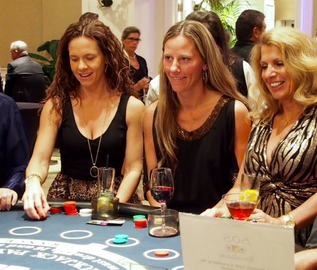 Rotary Casino Night goes Denim and Diamonds - A group of people sitting at a table - Girl