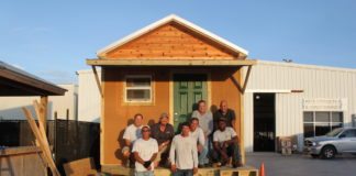 Tiny Homes: Can we do that here? - A group of people standing in front of a house - House