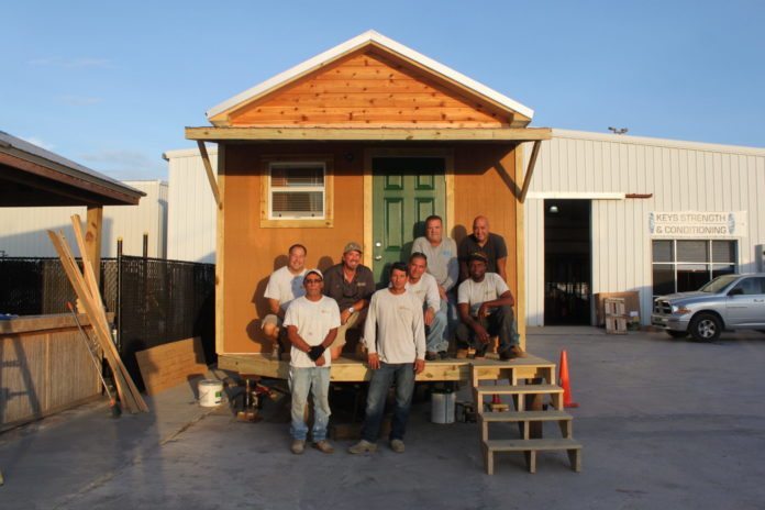 Tiny Homes: Can we do that here? - A group of people standing in front of a house - House