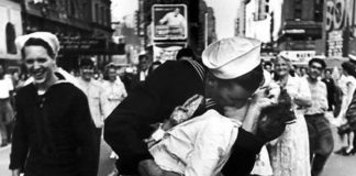 Locals celebrate ‘VJ Day’ - A group of people walking down a street - V-J Day in Times Square