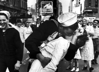 Locals celebrate ‘VJ Day’ - A group of people walking down a street - V-J Day in Times Square