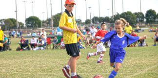 Just for Kicks - A group of young people playing football on a field - Gaelic football