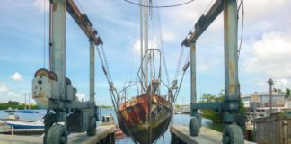  UNSUNKEN: County removes 16 derelict vessels - A truck is parked on the side of a bridge - Water
