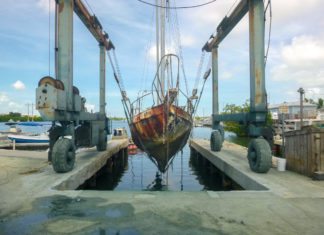  UNSUNKEN: County removes 16 derelict vessels - A truck is parked on the side of a bridge - Water