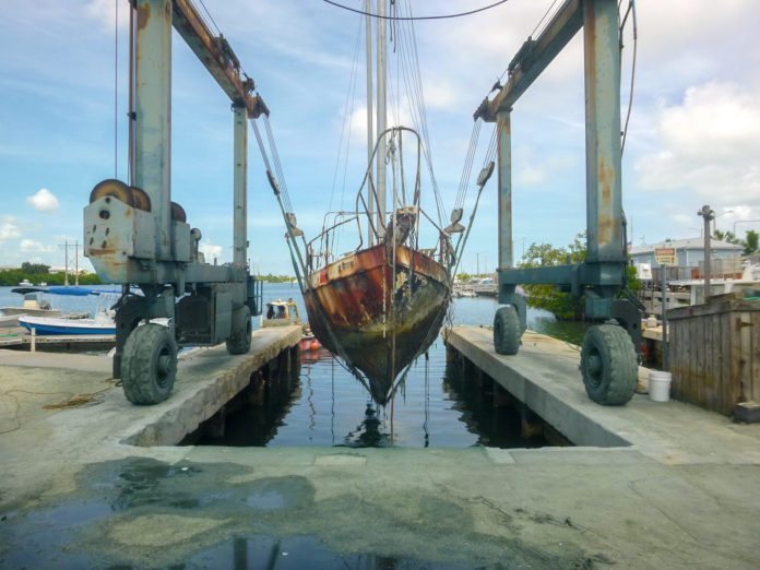  UNSUNKEN: County removes 16 derelict vessels - A truck is parked on the side of a bridge - Water