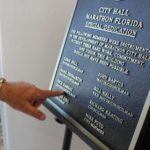 Marathon’s new City Hall - A hand holding a cell phone screen with text - Marathon