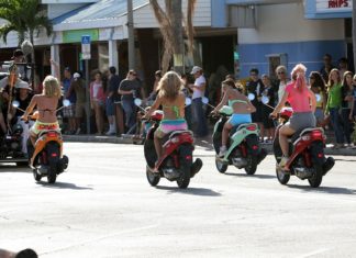 ON TWO WHEELS: Death and injury in Key West - A group of people riding on the back of a motorcycle - Scooter