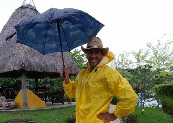 20 Questions with Kevin Johnsen - A man holding a yellow umbrella - Leisure