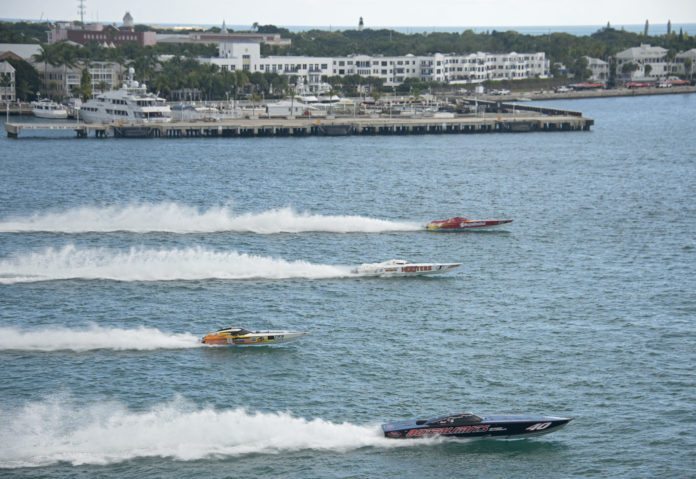 Fast Futures: Sponsoring Kids at Powerboat Races - A small boat in a body of water with a city in the background - Motor Boat