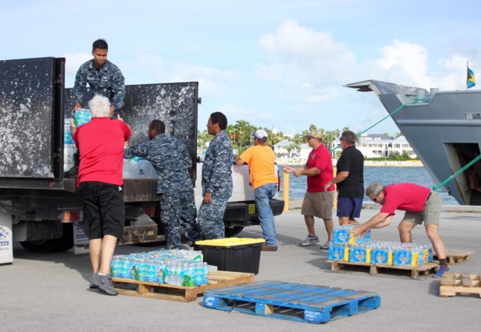 Keys Donations head to the Bahamas - A group of people sitting at a table - Vehicle