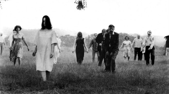 Get Eerie at Fort East Martello - A group of people standing on top of a grass covered field - Night of the Living Dead