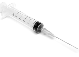 The Horrors of Heroin - A close up of a black device - Hypodermic needle