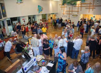 Upper Keys Event: Taste Around the World - A group of people in a room - Crowd