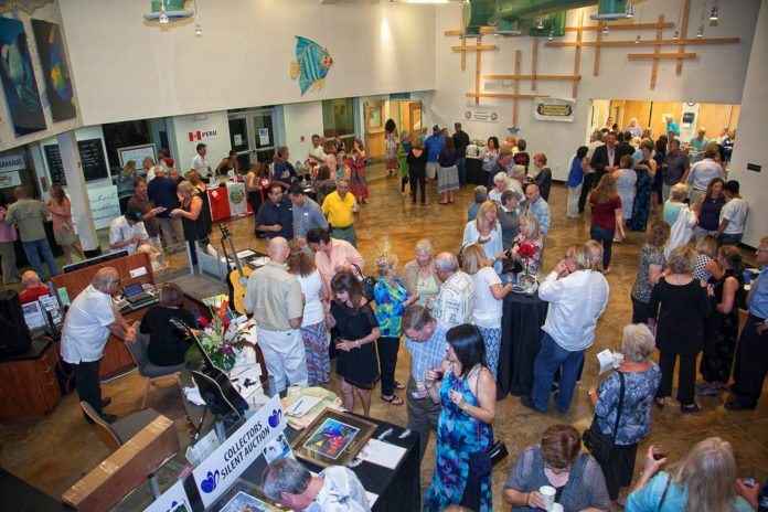 Upper Keys Event: Taste Around the World - A group of people in a room - Crowd