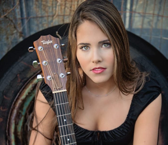 Rising star: Sanders focused on expanding horizons - A woman looking at the camera - Guitar