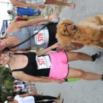 Cow Key Bridge Run: Show us your teats - A person holding a dog - Cow Key