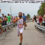 Cow Key Bridge Run: Show us your teats - A group of people holding a sign - Florida Keys