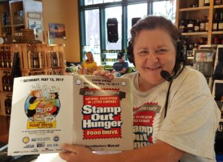 Stamp Out Hunger – Aiming for a record - A person sitting at a table in a restaurant - Stamp Out Hunger Food Drive